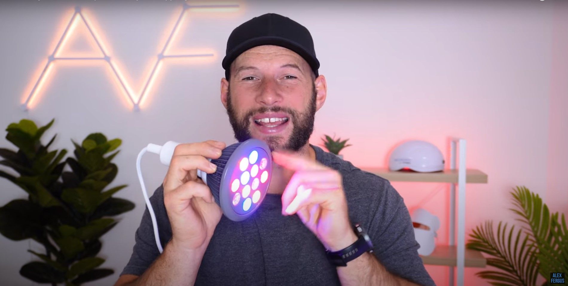 Alex holding a handheld beauty light therapy device