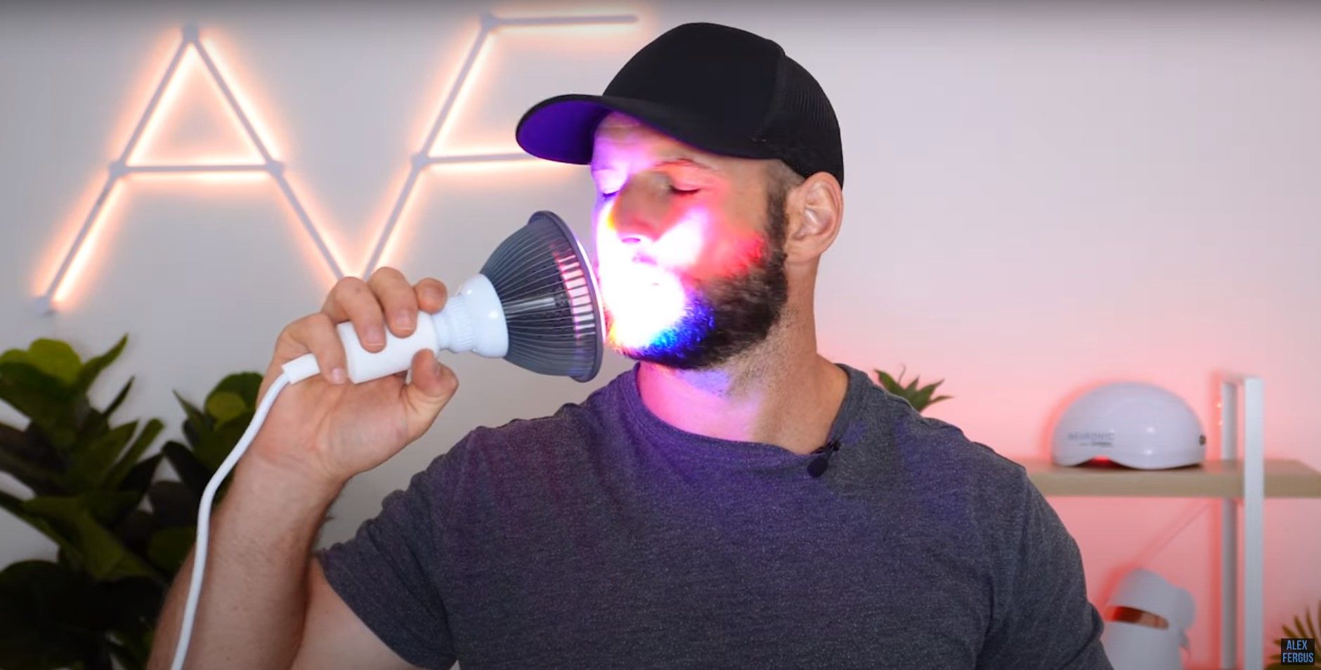 Alex shines the portable light therapy device on his face