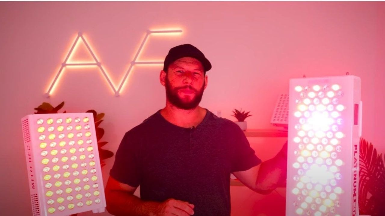 Alex Fergus standing between the MitoADAPT MIN and BioMAX 300 red light therapy panels
